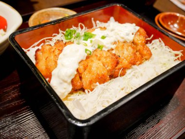 Chicken nanban or fried chicken with soy vinegar dressing and tartar sauce on top