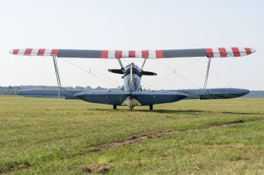 Soviet-made World War II green biplane on a grassy airfield