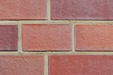 Modern kırmızı tuğlalı duvarın yakın plan fotoğrafı..