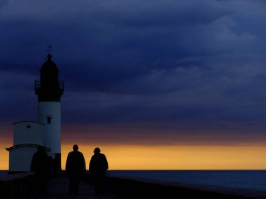 STORM 'DAN önce LE TREPORT Deniz feneri, Normandiya, FRANCE, alacakaranlıkta bulutlu bir gökyüzü altında, arka ışıklandırma, iskele sonunda Manş ve güneşin son ışınları, lense bakan üç koyu renkli fotoğraf,.