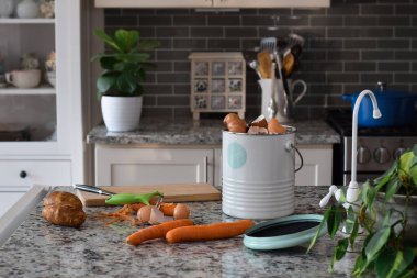 Composter with food scraps on kitcen counter top  clipart