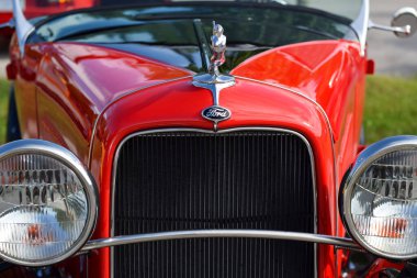 May 28, 2022 - East Gwillimbury, Ontario, Canada: Front view of old 1932 vintage red model B Ford classic car with flying lady or swimming nymph on hood ornament clipart