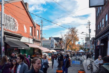 Toronto, Ontario, Canada - October 30, 2022: Crowd of people at Kensington Market on Sunday afternoon clipart