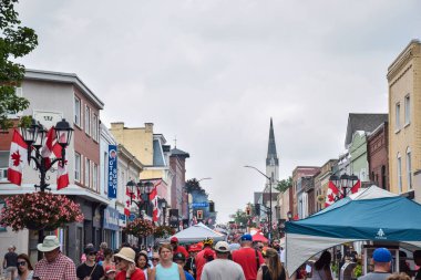 Newmarket, Ontario, Canada - July 1, 2023: People walking on Newmarket Main Street during Canada Day celebration clipart