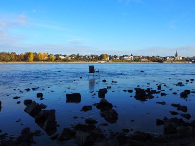 Chair standing in the Rhine's river bed in Bonn, Germany clipart