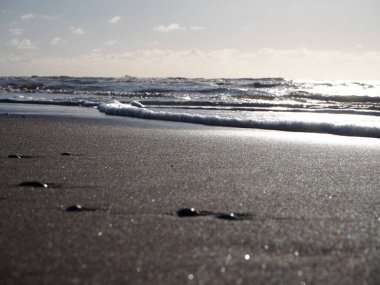 Close- up of waves crushing on the beach in Noordwijk, Netherlands clipart