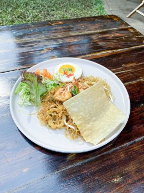 Kafedeki ahşap masada Tayland yemeği