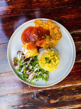 Tavuklu bir tabak ve sebzeli kızarmış patates.