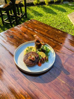 Ahşap arka planda sebzeli ızgara domuz eti.