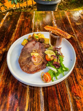 Sebze ve sos ahşap plaka üzerinde biftek