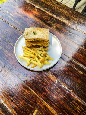 Tahta masada kızarmış patatesli sandviç.