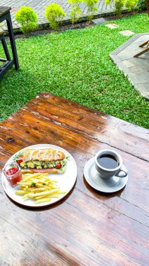Bahçedeki masada kahve fincanı ve çay.