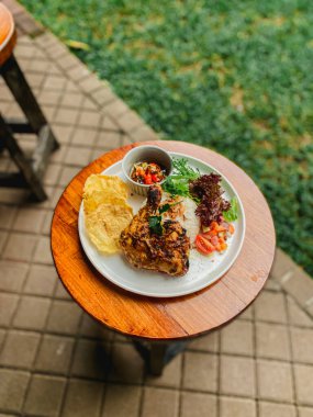 Ahşap masada ızgara tavuk ve pirinç.