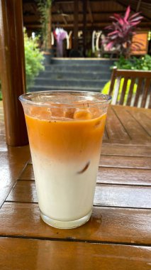 Ahşap arka planda buzlu kahve ve süt.