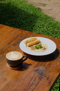 Sıcak kahve ve süt ahşap masada.