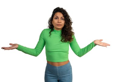 Studio portrait of a young woman shrugging her shoulders with open palms, expressing indifference and uncertainty clipart