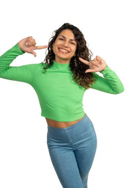 Gülümsemesini gösteren, diş tellerini ve mükemmel dişlerini gösteren neşeli genç bir kadının stüdyo portresi.