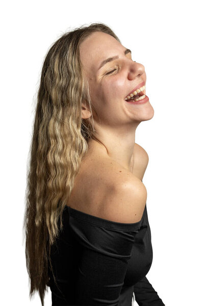 Woman in black top laughing joyfully against white background
