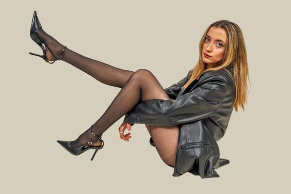 Stylish model showcasing confidence and fashion-forward attire in a studio setting