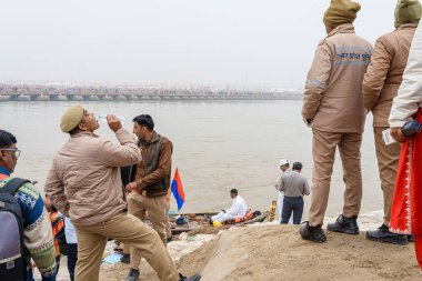 Uttar Pradesh police remain vigilant during the Shahi Snan of Makar Sankranti, overseeing the devotees as they take a sacred dip in the Ganga at Mahakumbh in Prayagraj. clipart