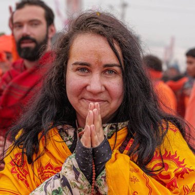 14 January, 2025, Prayagraj, uttar Pradesh, India. A foreigner woman devotee walks towards the Sangam, her heart filled with reverence, preparing for the holy dip, embracing the spiritual essence of the sacred waters. clipart