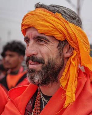 14 January, 2025, Prayagraj, uttar Pradesh, India. A foreigner Babaji, deeply immersed in spiritual devotion, walks towards the Sangam, embodying the universal quest for peace and enlightenment. clipart