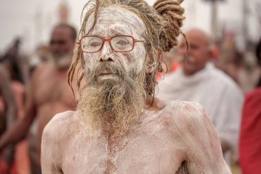 14 January, 2025, Prayagraj, uttar Pradesh, India. A Naga Sadhu, his eyes hidden behind glasses, gazes with intensity after the holy bath, his unique look blending spirituality with modernity. clipart