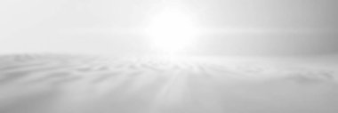 Shimmering bright light over a tranquil, white landscape. clipart