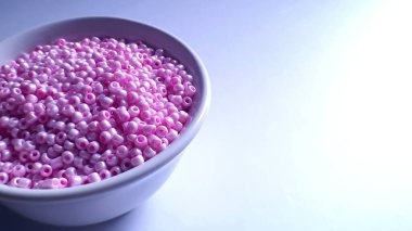 Small Pink Beads in a Ceramic Bowl clipart