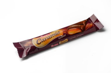 Gaziveren Cyprus -22.01.2025 A delectable caramel-filled treat wrapped in vibrant packaging sits invitingly on a shop counter. clipart