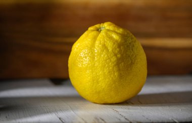 Canlı bir limon yumuşak ışıkta dokusu ile parlar, aşçılık ilhamı için mükemmeldir..