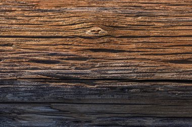 Close-up view of a rustic wooden surface highlighting intricate grains and natural patterns illuminated by sunlight. clipart