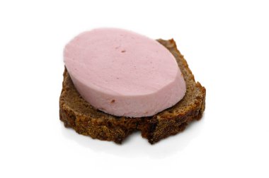 A slice of dark rye bread topped with a creamy pink spread makes for a simple yet satisfying midday meal. clipart