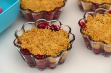 Miniature cherry crumble cups filled with tart berries and crispy topping create a tempting dessert for gatherings. clipart