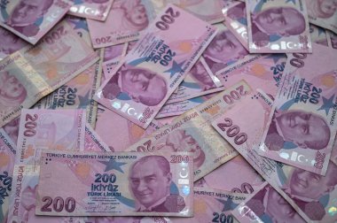 A colorful collection of Turkish banknotes lies scattered, showcasing their intricate details and cultural significance. clipart