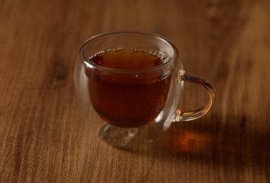 Zengin kehribar sıvısı narin bir cam bardakta nazikçe kıvrılır, sakin bir sabahta rahatlamaya ve tefekküre davet eder..