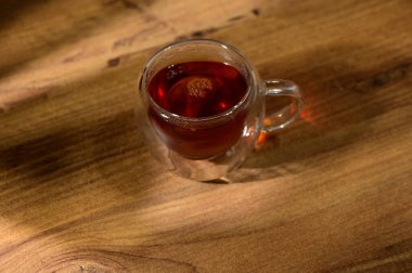 Sıcak bir atmosferde bitki çayının sıcaklığının tadını çıkarmak, öğleden sonra güneşinin yumuşak parıltısıyla yıkanmak..