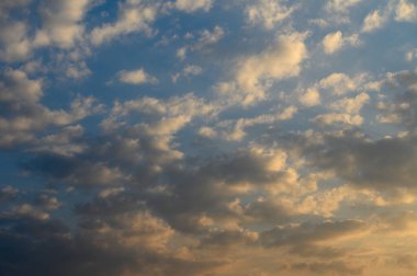 Güneş batarken renkler harmanlanır ve ufkun üzerinde huzur içinde süzülen yumuşak bulutlar üzerinde ılık bir parıltı bırakır..