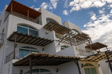 Modern binalar zarif tasarım ve açık hava alanlarını pofuduk bulutlar ve güneş ışığına karşı sergiliyor..