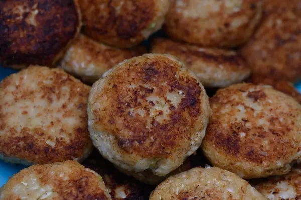 Deliciously fried patties stacked together, showcasing a crispy exterior and fluffy interior, perfect for any meal.