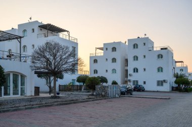 Alacakaranlıkta sakin bir an modern mimari sıcak ışıkla yıkanmış, rahatlatıcı bir atmosfer yaratıyor..