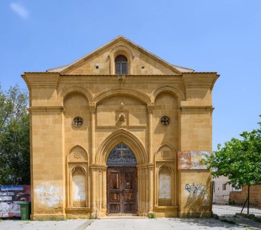Görkemli ama terk edilmiş bina vitrinleri mimari detayları ve yıpranmış dokuları canlı mavi gökyüzünün arka planına karşı. Çevredeki bölge kayıp güzelliği gösteriyor..