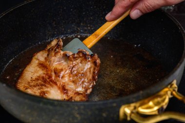 Sulu et bir tavada ustalıkla ters çevrilir ve canlı bir mutfak ortamında ağız sulandırıcı kokular yayar..