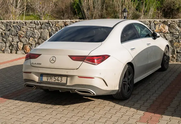 Gaziveren Kıbrıs Rum Kesimi -28.02.2025 Şık lüks bir sedan, zarif tasarımını ve güneşli gökyüzünün altında ince tozunu sergileyerek doğanın arasında sessizce oturuyor.