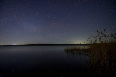 Dinyeper Nehri 'nin sakin sularına yansıyan yıldızlı gökyüzünün göz kamaştırıcı gece görüntüsü dingin ve büyülü bir sahne yaratıyor..
