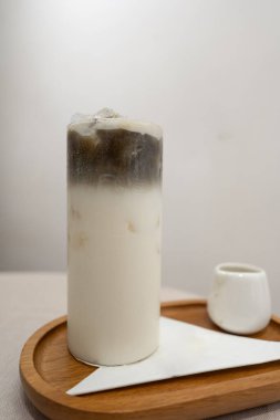 Beyaz masadaki ahşap tepside sütlü kavrulmuş yeşil çay.