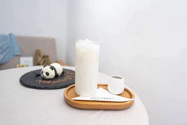 panda cake  and ice roasted green tea latte on a black plate on white table at cafe