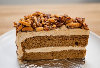 Karamelli bademli şekerleme. Tahta bir masada, ayrı bir konteynırda, kahverengi iğne kahveli kek.