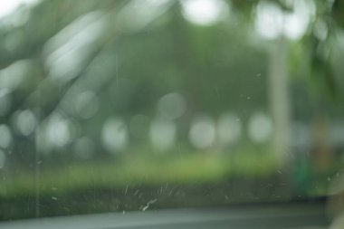 Bulanık arkaplan ile pencereye düşen yağmur damlaları