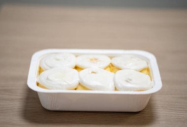 Masada bir tepsi dondurulmuş tarçınlı rulo